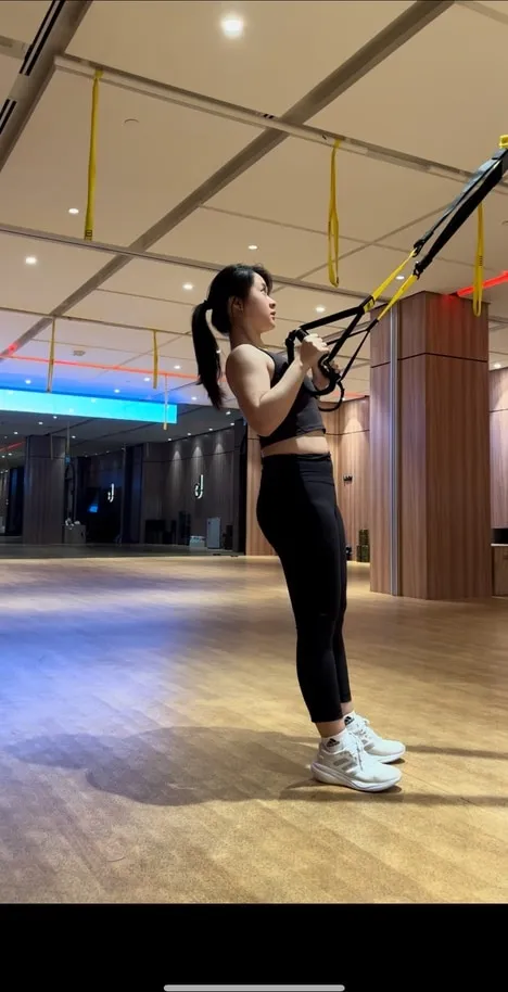 A client training with suspension straps under Jeremiah Lung's coaching